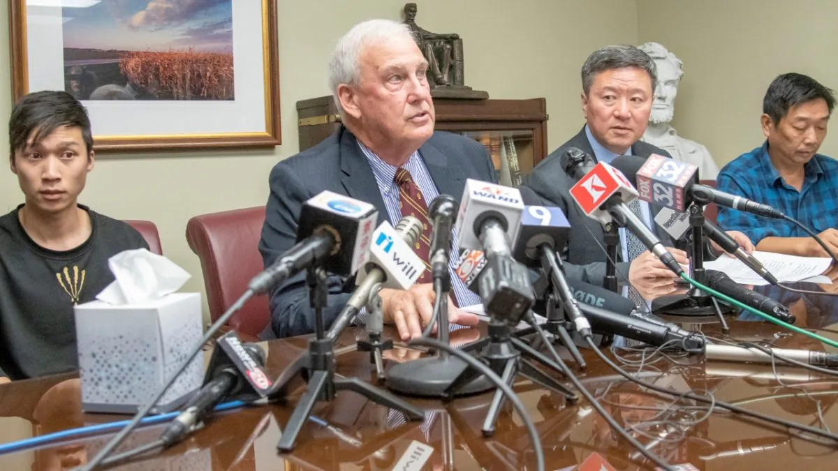 (L-R) Yingying Zhang's brother Zhengyang Zhang, Attorney Steve Beckett, Attorney Zhidong Wang, and Yingying's father Ronggao Zhang appear at a press conference at Beckett's law office in Urbana, Ill., on Aug. 7, 2019. (Robin Scholz/The News-Gazette via AP )