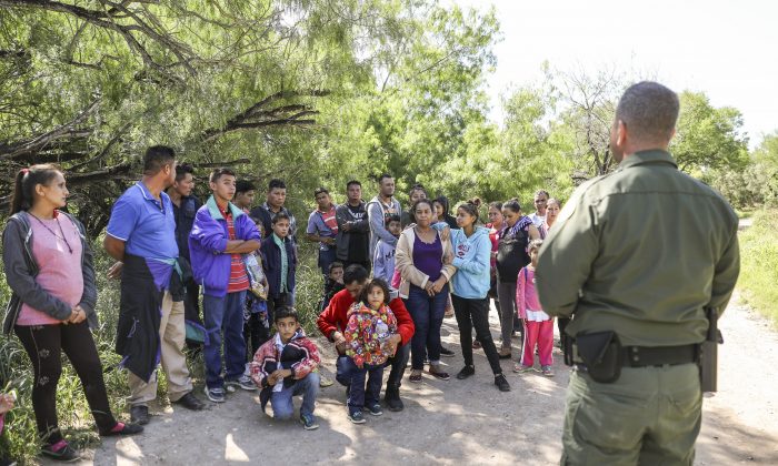 Border Patrol agent Carlos Ruiz apprehends 35 illegal aliens who have just crossed the Rio Grande from Mexico near McAllen, Texas, on April 18, 2019. (Charlotte Cuthbertson/The Epoch Times)