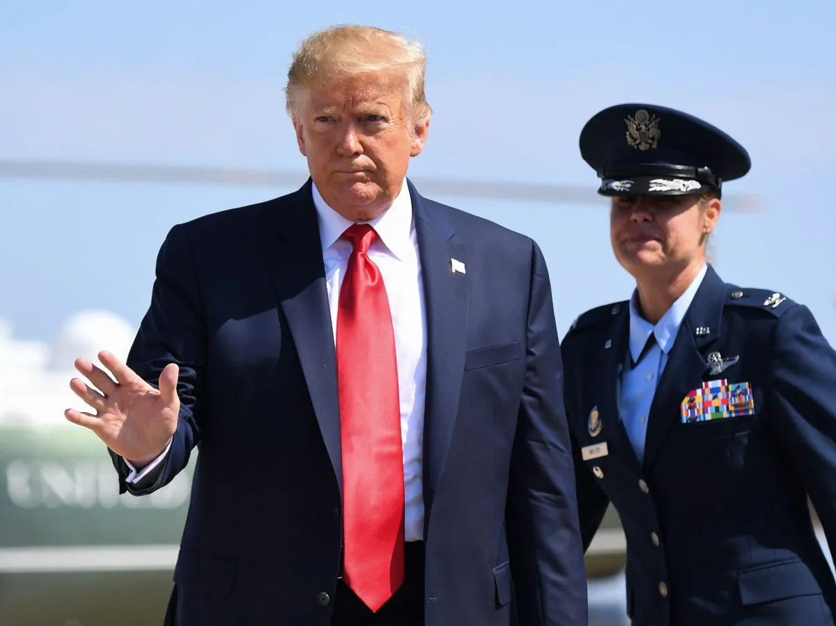 President Donald Trump waves before boarding Air Force One prior to departing from Joint Base Andrews, Md., on Aug. 9, 2019. (Saul Loeb/AFP/Getty Images)