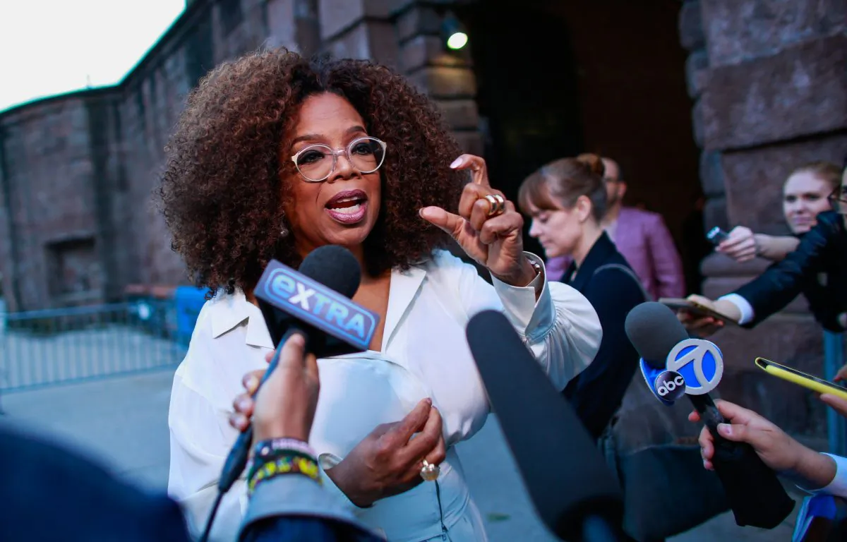 U.S. media executive and talk show host Oprah Winfrey talks to the press as she arrives to the opening celebration of the Statue of Liberty Museum on Liberty Island at the Statue Cruises Terminal in Battery Park in New York on May 15, 2019. (Kena Betancur/AFP/Getty Images)