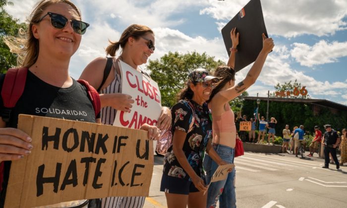 People hold up signs protesting against the U.S. Immigration and Customs Enforcement agency in New York City on August 10, 2019. (David Dee Delgado/Getty Images)