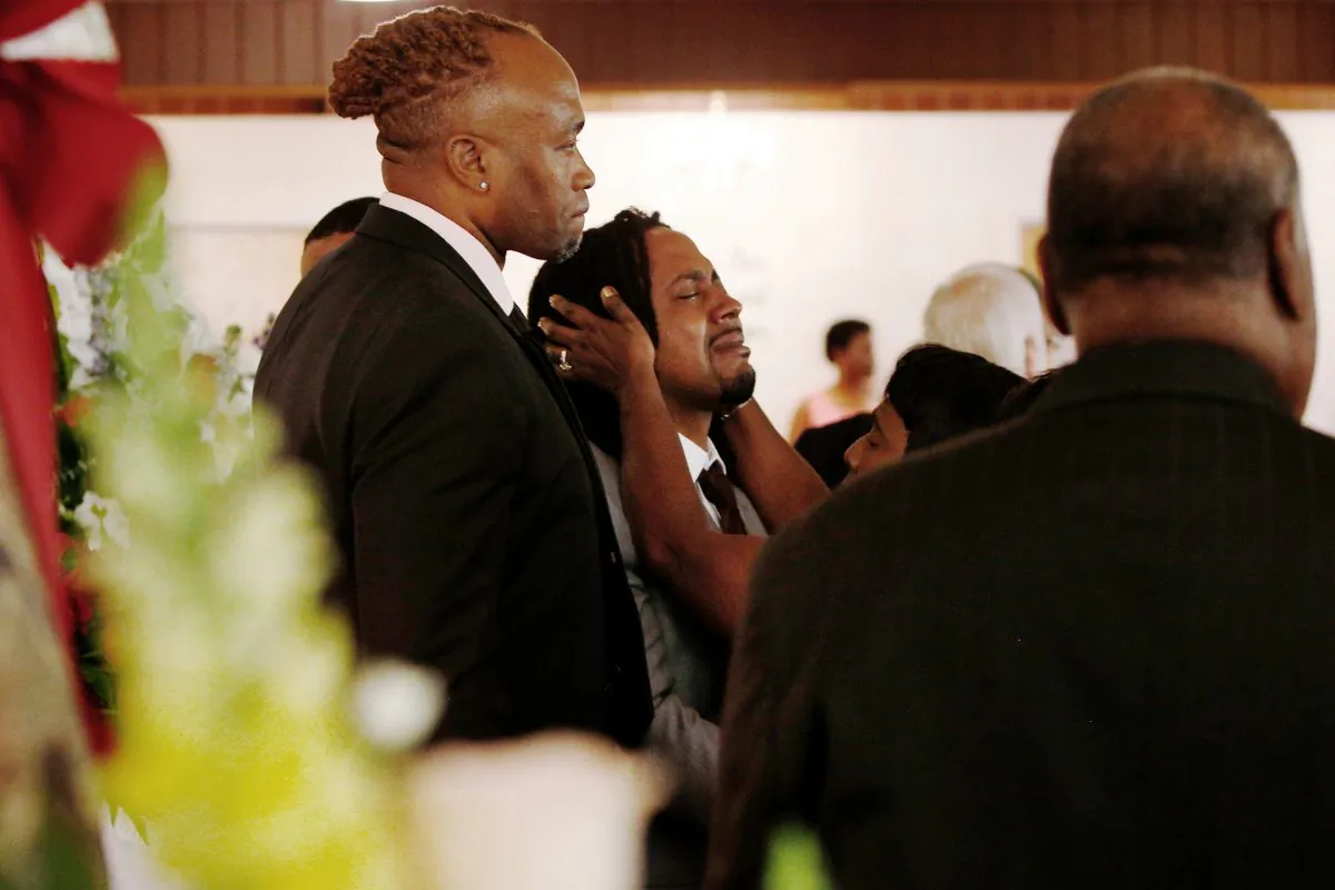 A relative attempts to console Dion Green (C), before the funeral for his father, Derrick Fudge, on Aug. 10, 2019, at a church in Springfield, Ohio. (Angie Wang/AP)