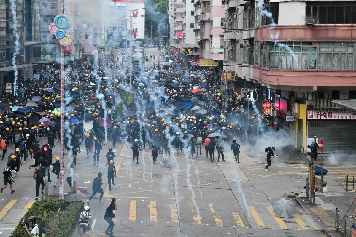 Pro-democracy protesters throw back tear gas fired by the police during a demonstration against the controversial extradition bill in Sham Shui Po district in Hong Kong on Aug. 11, 2019. (Anthony Wallace/AFP/Getty Images)
