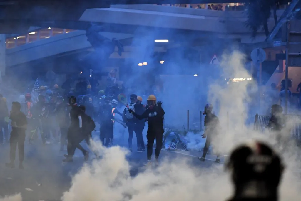 Protesters throw back tear gas canisters fired by the police in Tai Wai in the New Territories of Hong Kong on Aug. 10, 2019. (Manan Vatsyayana/AFP/Getty Images)