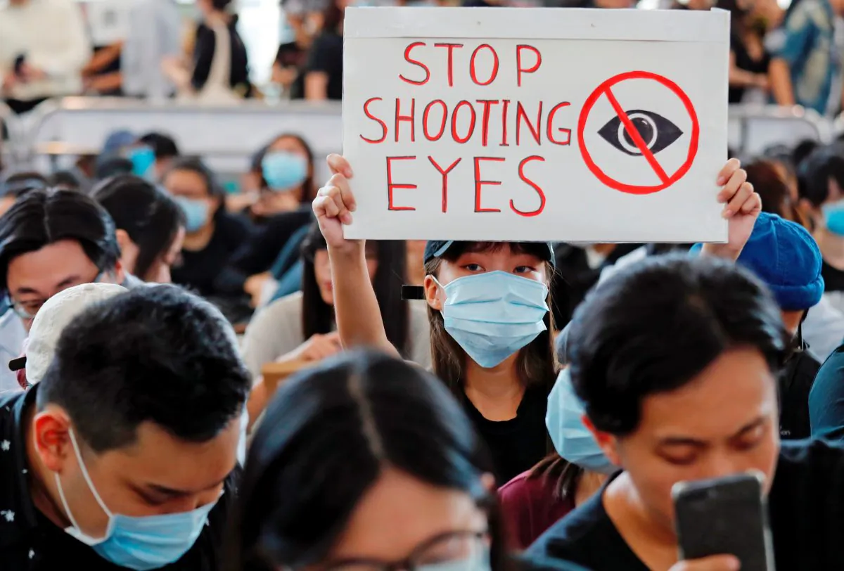 Anti-extradition bill protesters attend a mass demonstration after a woman was shot in the eye during a protest at Hong Kong International Airport, in Hong Kong, China August 12, 2019. REUTERS/Tyrone Siu