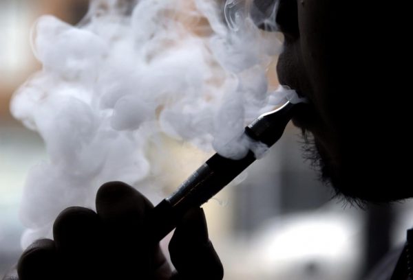 A man smokes an electronic cigarette in Chicago on April 23, 2014. (AP/Nam Y. Huh, File/The Canadian Press)