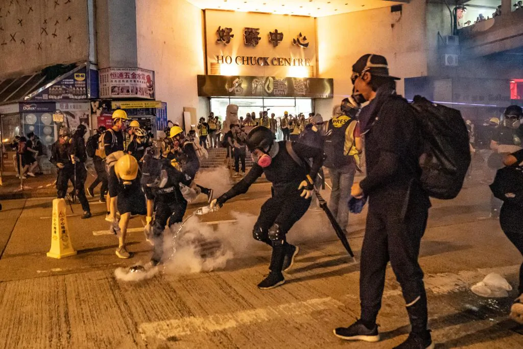 Protesters put out the tear gas as they pour water on it at Kwai Fong district, Hong Kong, on Aug. 11, 2019. (Anthony Kwan/Getty Images)