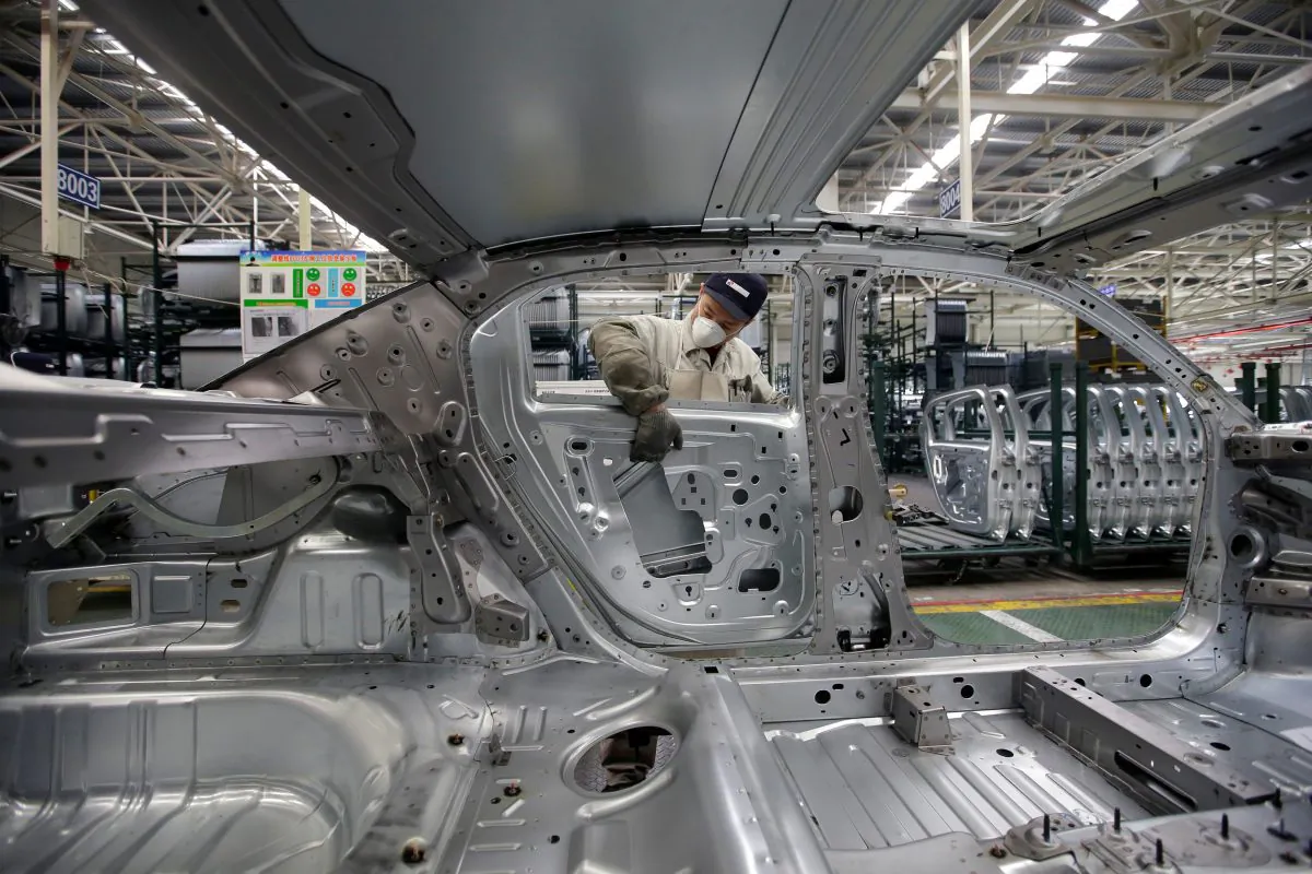 An employee installs car doors at a production line of Dongfeng Peugeot Citroen Automobile factory in Wuhan, Hubei Province, China on Feb. 13, 2014. (Darley Shen/Reuters)