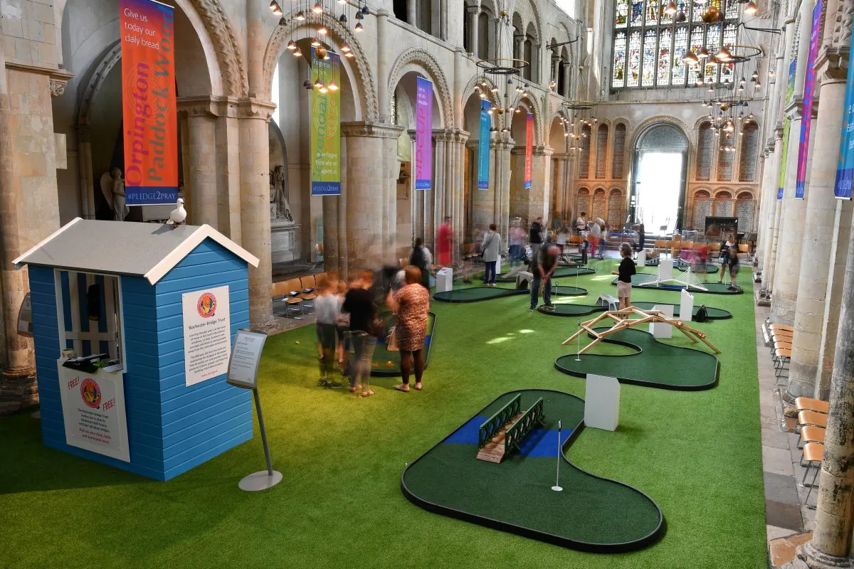 People play on the bridge-themed mini-golf course set up in the nave of Rochester Cathedral in Rochester, southeast England, on August 6, 2019. BEN STANSALL/AFP/Getty Images