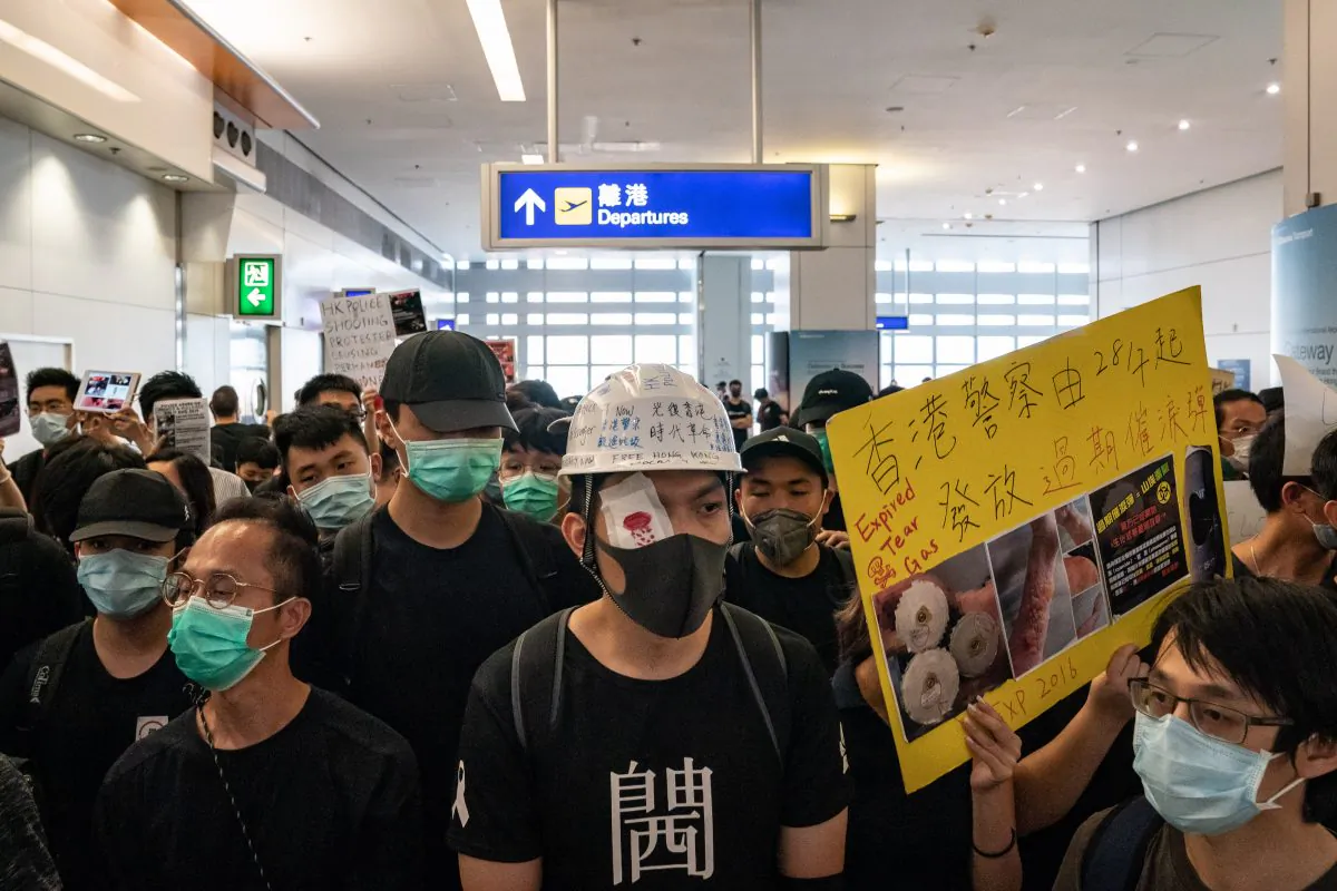 Protesters hold placards as they block the departure gate of the Hong Kong International Airport Terminal 2 during a demonstration in Hong Kong, on Aug. 13, 2019. (Anthony Kwan/Getty Images)