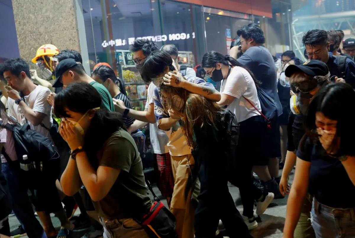 Anti-extradition bill protesters react after the police fired tear gas to disperse the demonstration at Sham Shui Po, in Hong Kong on Aug. 14, 2019. (Reuters/Tyrone Siu)