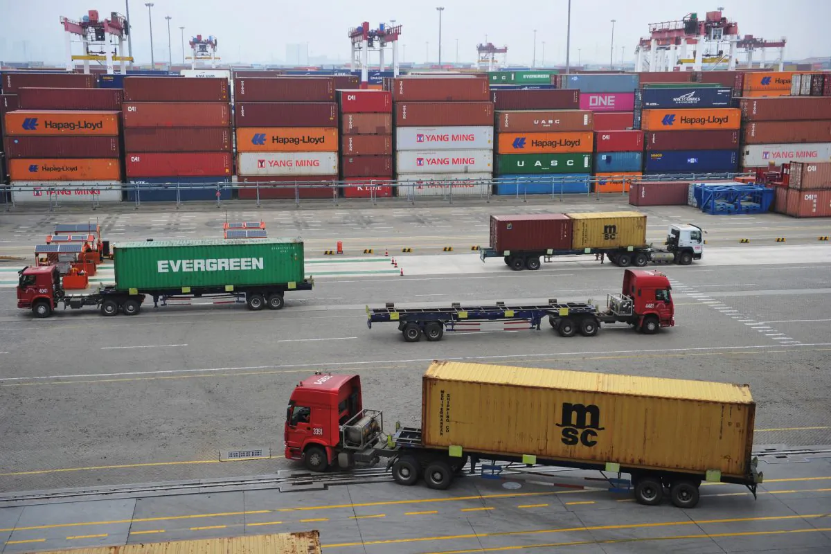 Trucks transport containers at a port in Qingdao, Shandong Province, China on July 11, 2019. (Reuters)