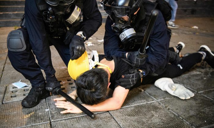 Police arrest a man during protests in Tsim Sha Tsui in Hong Kong on Aug. 11, 2019. (Anthony Wallace/AFP/Getty Images)