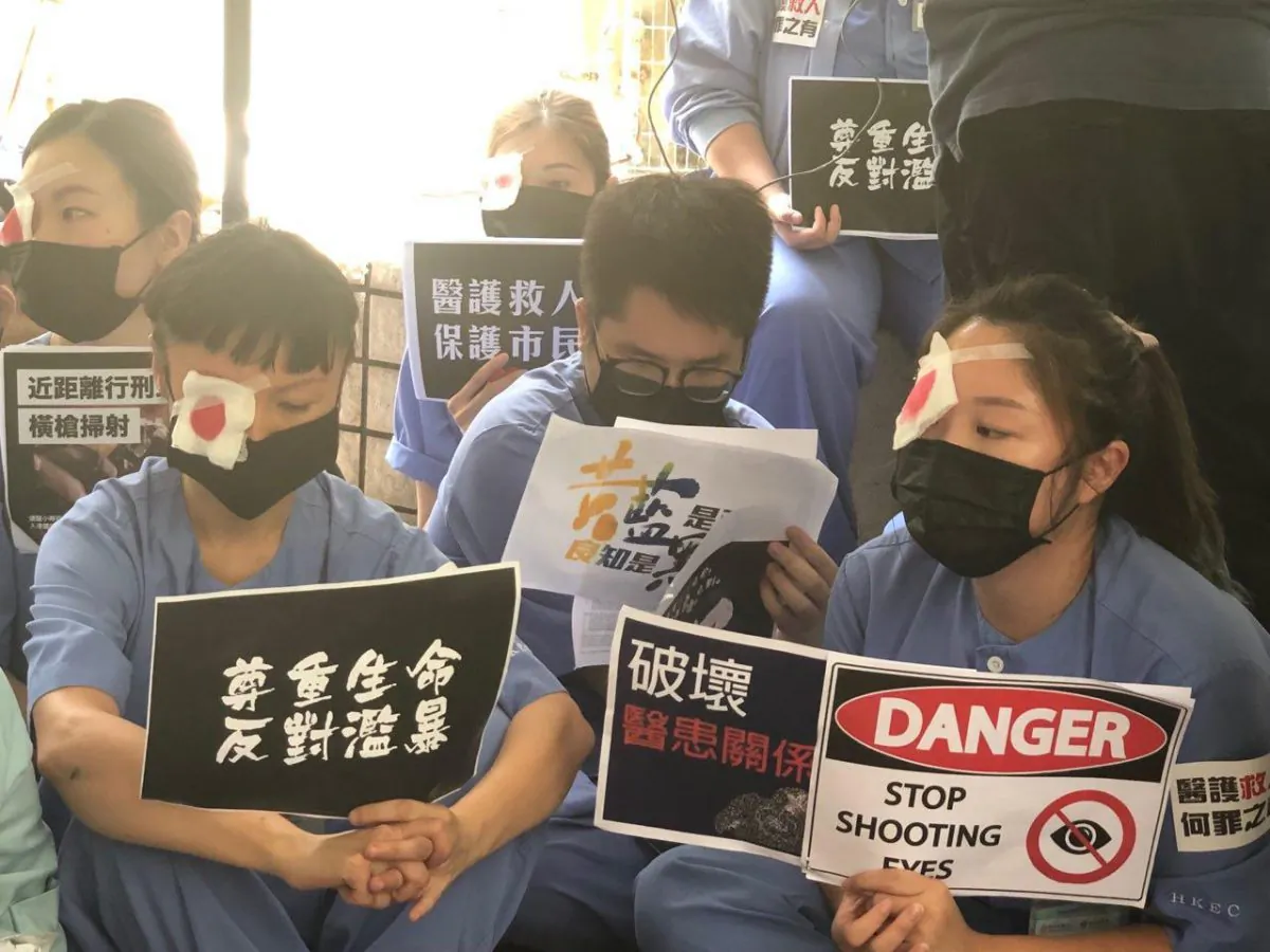 Hundreds of hospital workers from Ruttonjee and Tang Shiu Kin hospitals in Hong Kong staged another sit-in outside Ruttonjee Hospital on Aug. 14 in support of the protesters and condemned the brutality of the police.  (Ye Yifan/Epoch Times)