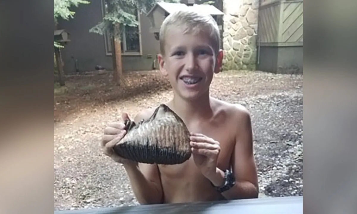 Jackson Hepner holds his discovery in Millersburg, Ohio. (Courtesy The Inn at Honey Run)