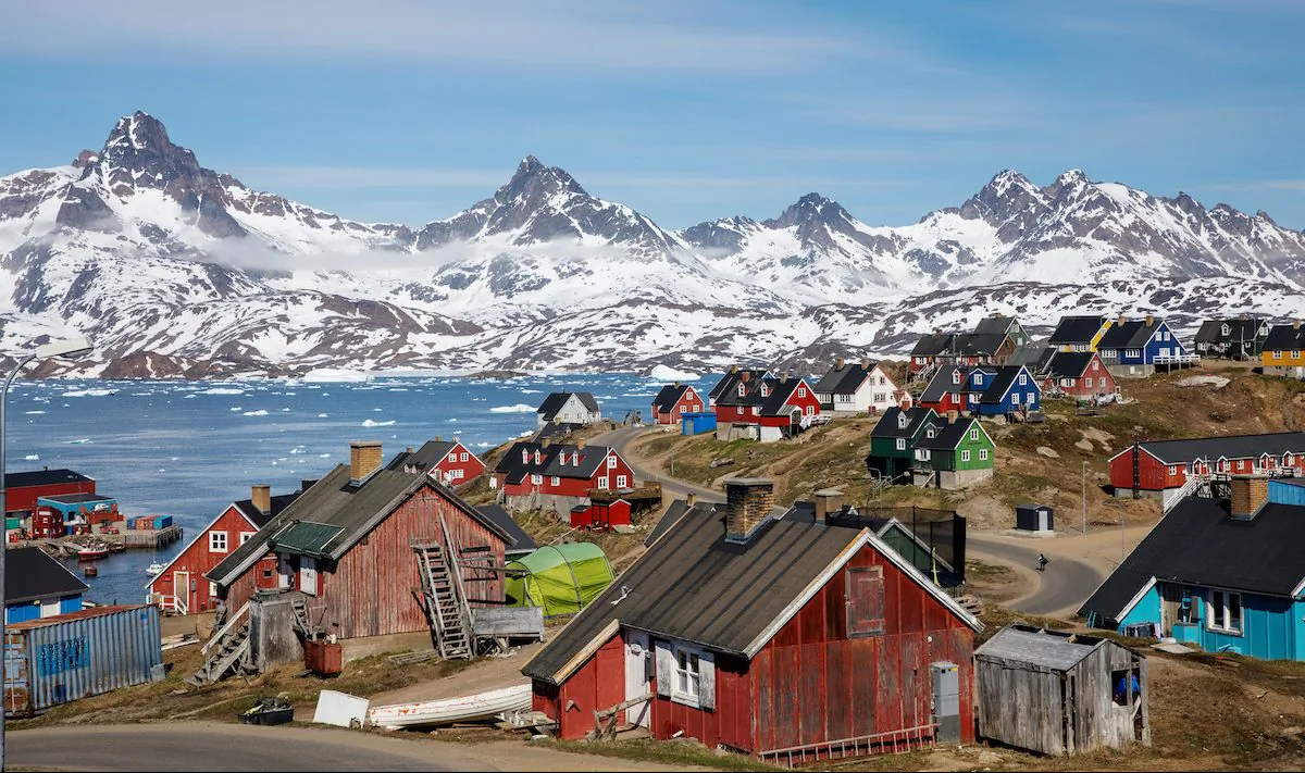 Snow covered mountains rise above the harbor and town of Tasiilaq, Greenland, June 15, 2018. (REUTERS/Lucas Jackson/File Photo)