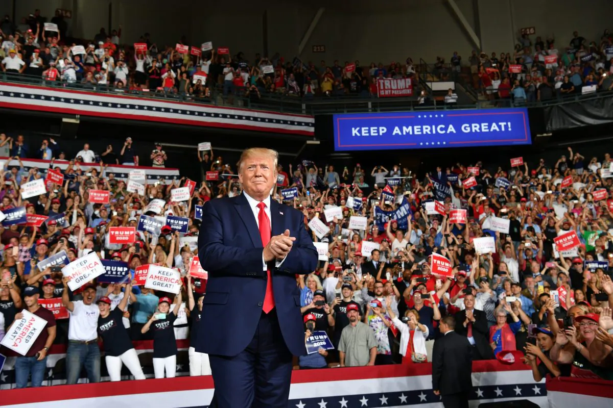 President Donald Trump salutes his supporters after a "Keep America Great" campaign rally at the SNHU Arena in Manchester, New Hampshire, on Aug. 15, 2019. (NICHOLAS KAMM/AFP/Getty Images)