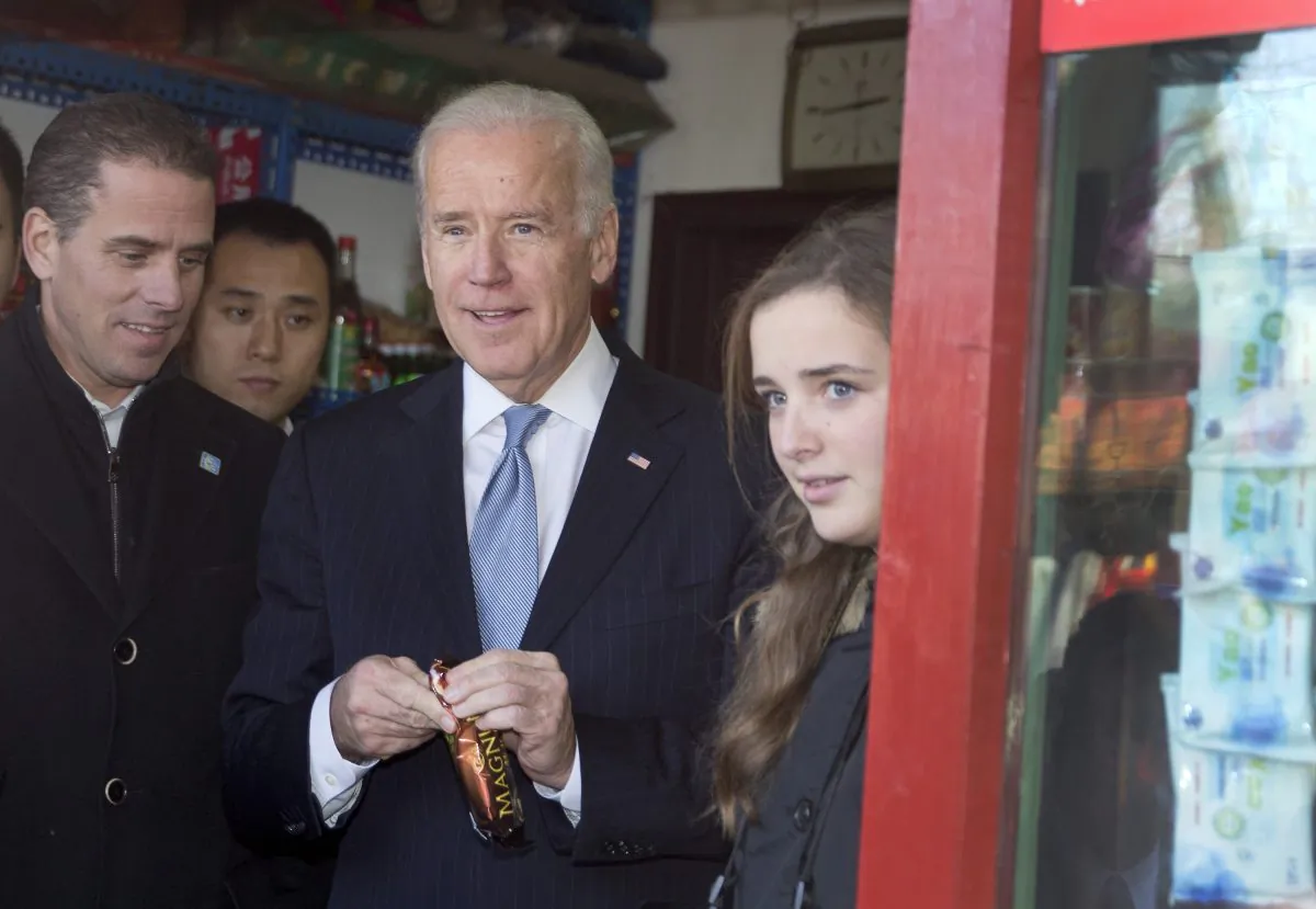 Vice President Joe Biden, center, buys an ice-cream at a shop as he tours a Hutong alley with his granddaughter Finnegan Biden, right, and son Hunter Biden, left in Beijing, China, on Dec. 5, 2013. (Andy Wong-Pool/Getty Images)