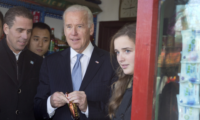 Vice President Joe Biden, center, buys an ice-cream at a shop as he tours a Hutong alley with his granddaughter Finnegan Biden, right, and son Hunter Biden, left in Beijing, China, on Dec. 5, 2013. (Andy Wong-Pool/Getty Images)
