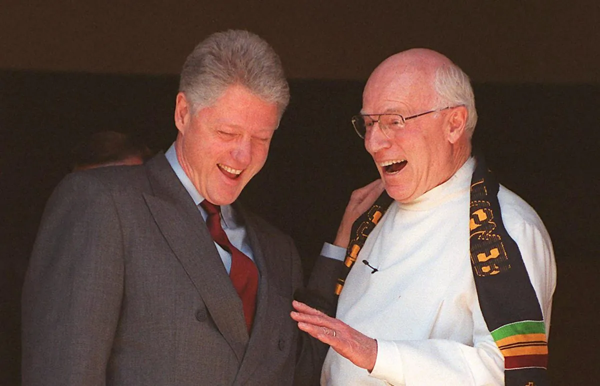 President Bill Clinton (L) laughs with Foundry Methodist Church Pastor Philip Wogaman after Sunday Services in Washington on Feb. 14, 1999. (Tim Sloan/AFP/Getty Images)