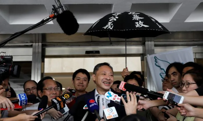 Pro-democracy activist Benny Tai (C) talks to reporters outside the High court, after being released on bail, in Hong Kong on Aug. 15, 2019. (Vincent Yu/AP Photo)