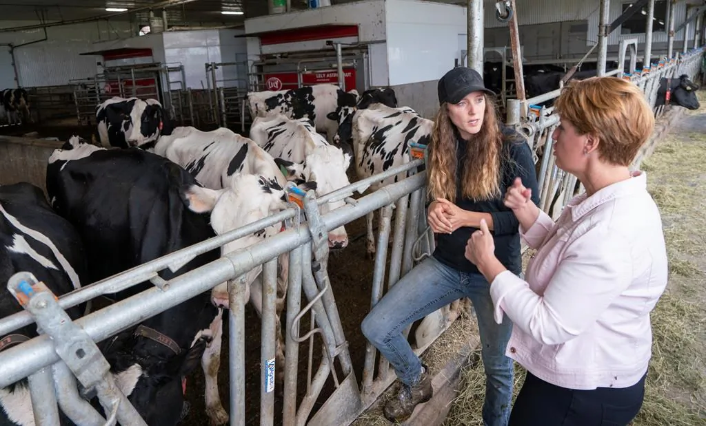 Marie-Claude Bibeau, Minister of Agriculture and Agri-Food, chats with farm owner Veronica Enright at her dairy farm in Compton, QB, Aug. 16, 2019. (Paul Chiasson/The Canadian Press)