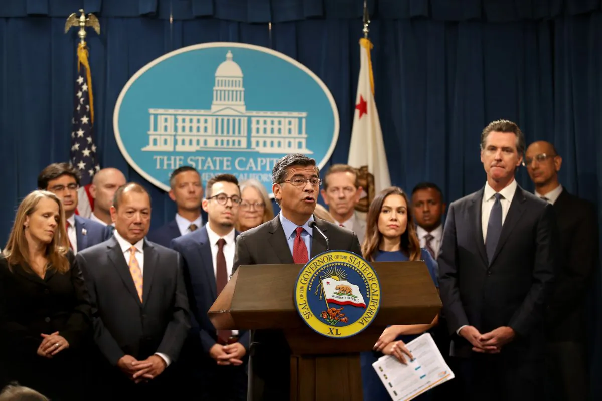 California attorney General Xavier Becerra (C) speaks during a news conference with California Gov. Gavin Newsom (R) at the California State Capitol in Sacramento, Calif., on Aug. 16, 2019. (Justin Sullivan/Getty Images)