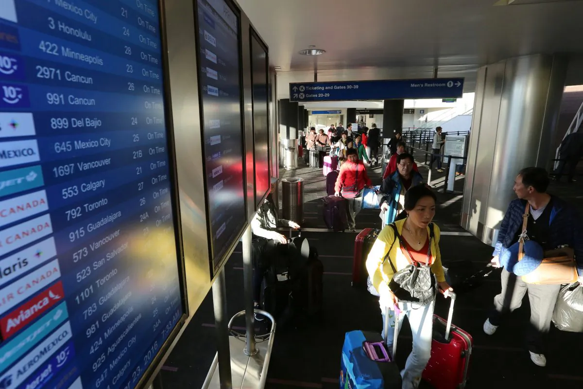 Travelers pass through Los Angeles International Airport (LAX) on the day before Thanksgiving in Los Angeles on Nov. 23, 2016. (Reuters/David McNew)