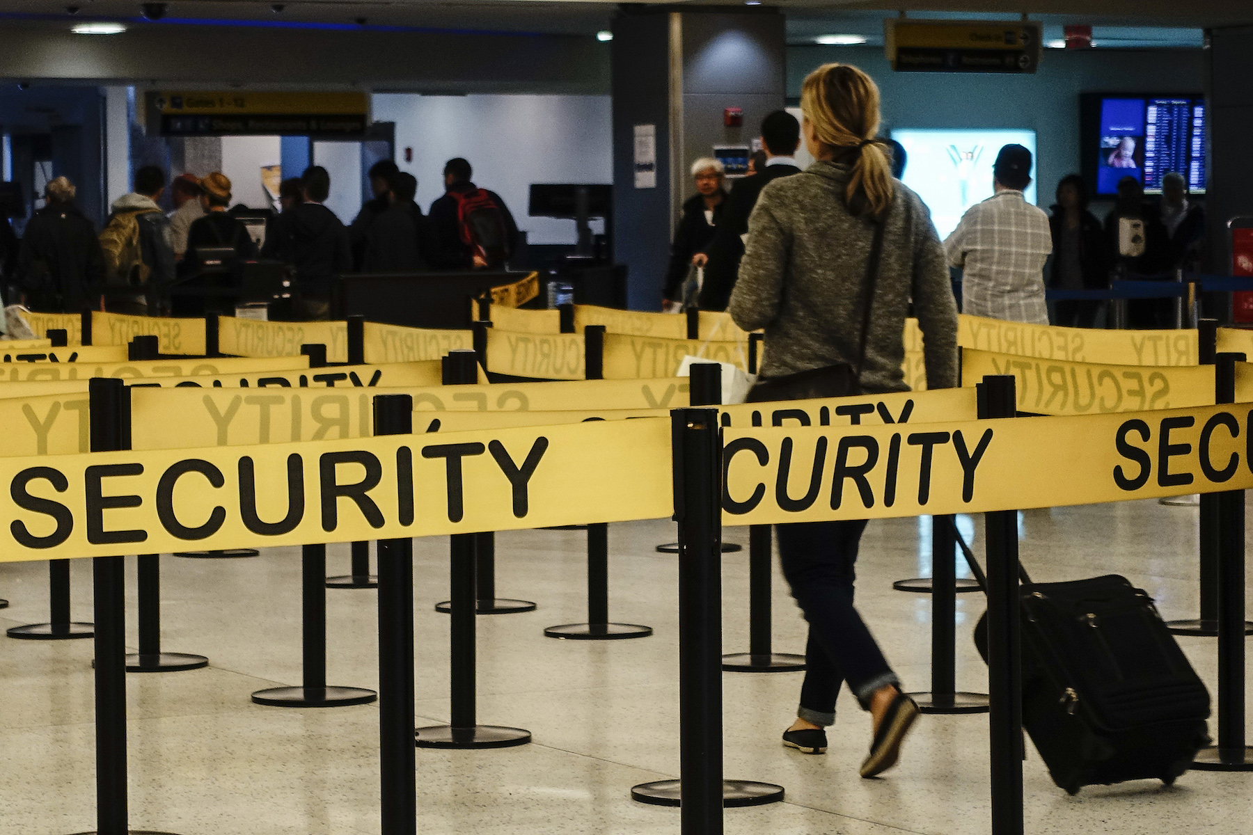 Passengers make their way in a security checkpoint at the International JFK airport in New York