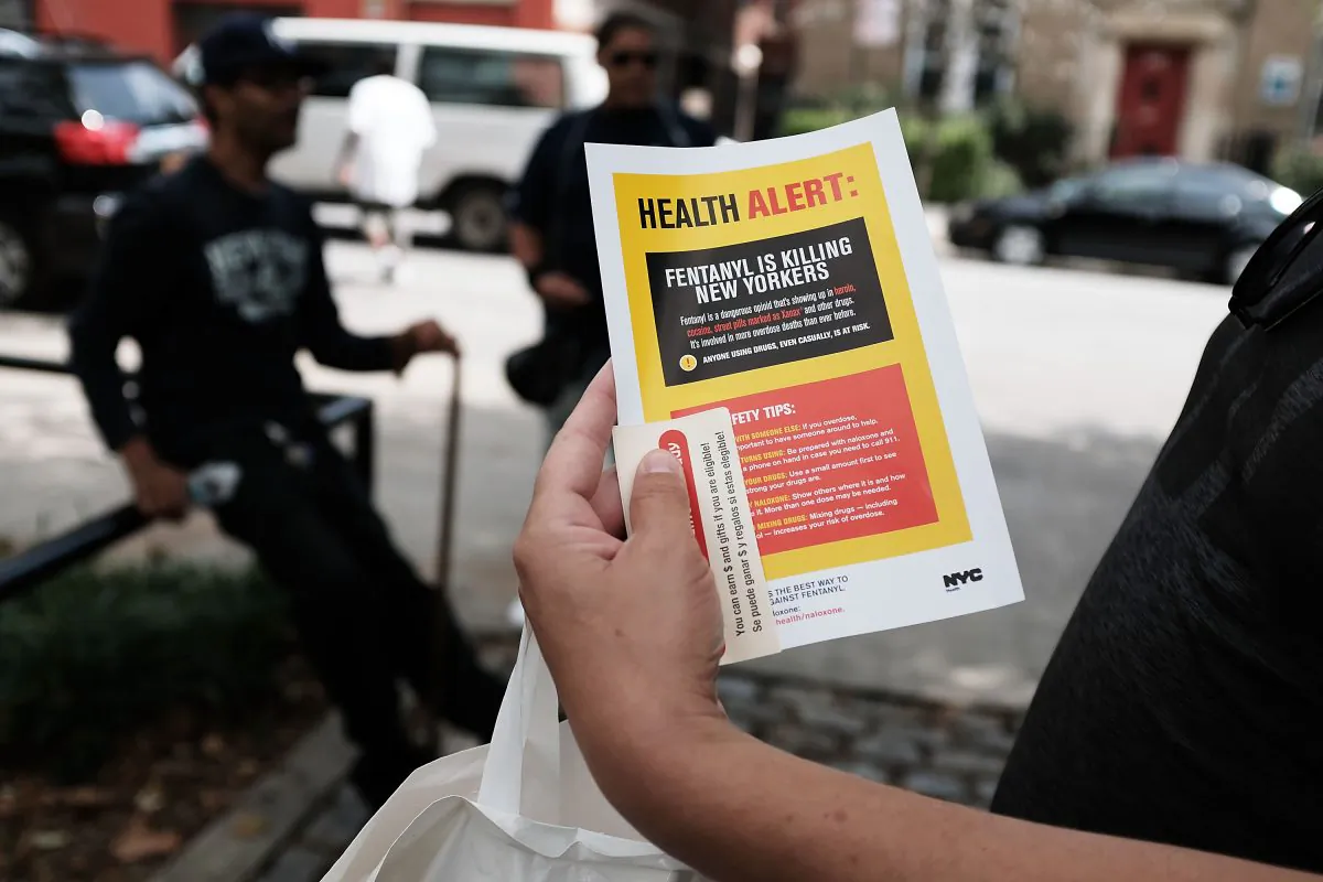 A heroin user reads an alert on fentanylon Aug. 8, 2017 in New York City. (Spencer Platt/Getty Images)