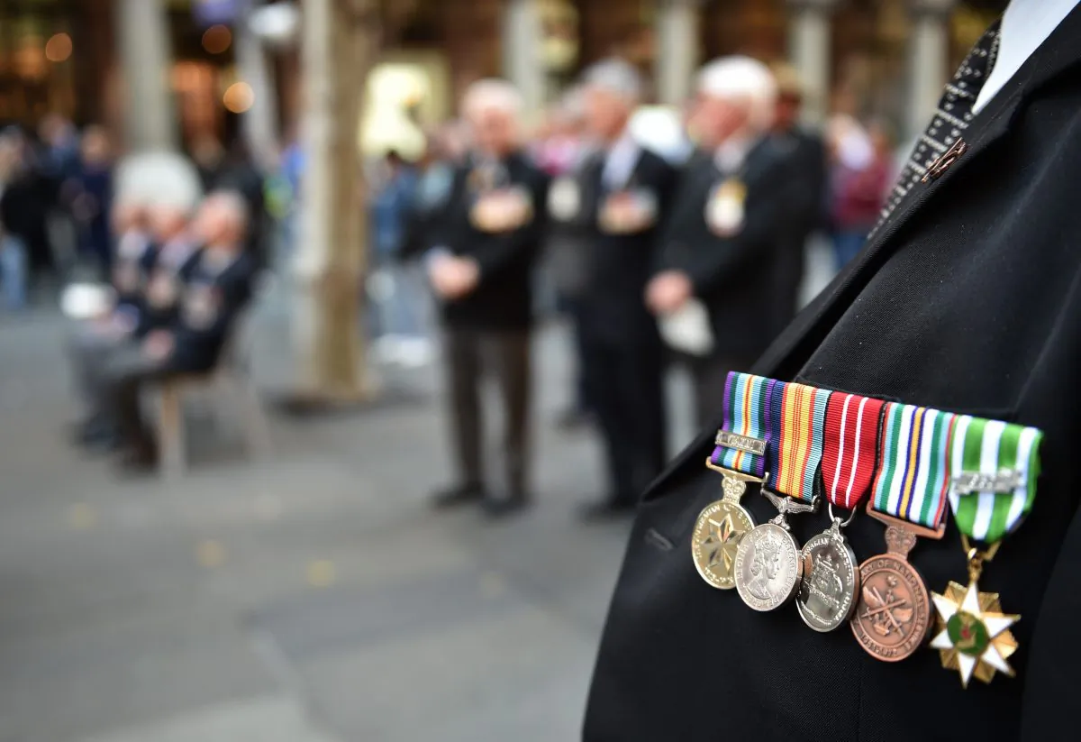 An Australian war veteran wears his medals, including a service medal from the Vietnam war (Far-L), at the 50th anniversary of the Vietnam Veterans Memorial Service in Sydney on Aug. 18, 2016. (PETER PARKS/AFP/Getty Images)