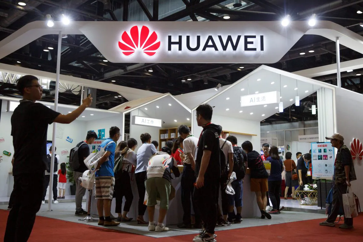 People look at products at the Huawei stall at the International Consumer Electronics Expo in Beijing, on Aug. 2, 2019. (Thomas Peter/Reuters)