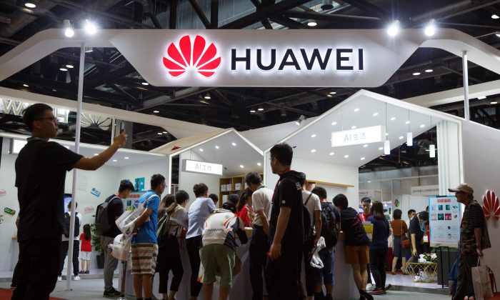 People look at products at the Huawei stall at the International Consumer Electronics Expo in Beijing, on Aug. 2, 2019. (Thomas Peter/Reuters)