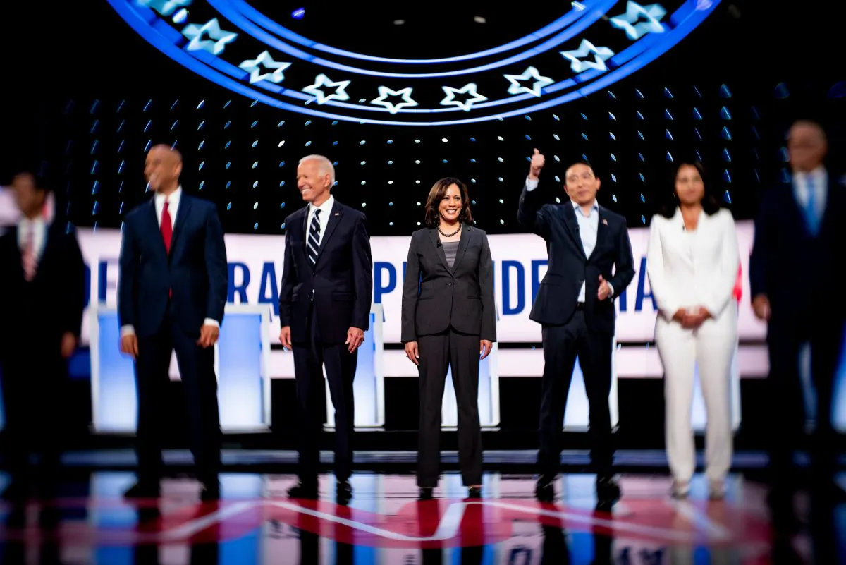 Democratic presidential hopefuls (L–R) former US Secretary of Housing and Urban Development Julian Castro, Sen. Cory Booker (D-N.J.), former Vice President Joe Biden, Sen. Kamala Harris (D-Calif.), entrepreneur Andrew Yang, Rep. Tulsi Gabbard (D-Hawaii), and Washington Gov. Jay Inslee arrive on stage ahead of the second round of the second Democratic primary debate of the 2020 presidential campaign season hosted by CNN at the Fox Theatre in Detroit, Michigan on July 31, 2019. (Brendan Smialowski/AFP/Getty Images)