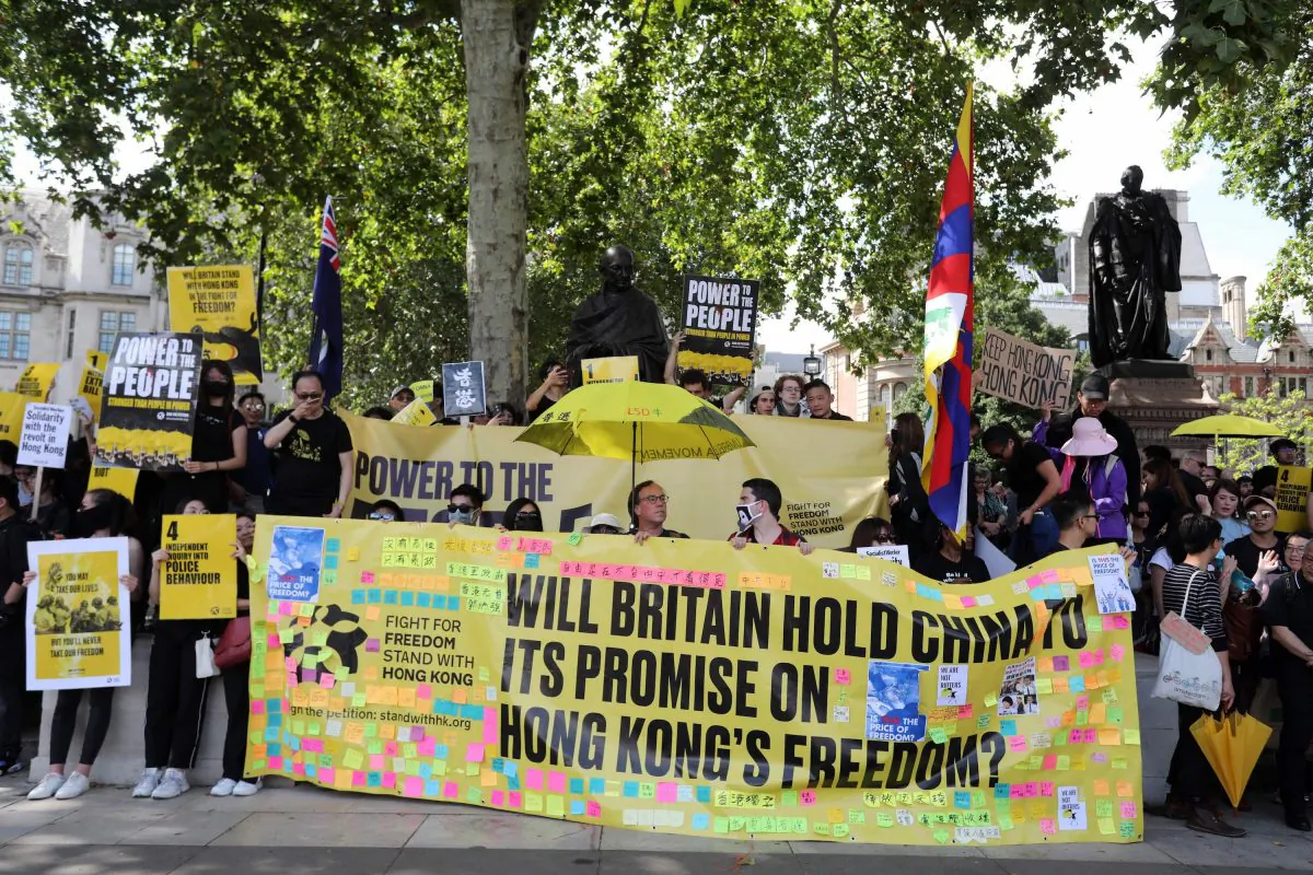 Protesters hold up placards as they gather in central London to attend a march organized by StandwithHK and D4HK  in support of pro-democracy protests in Hong Kong, on Aug. 17, 2019. (Isabel Infantes/AFP/Getty Images)