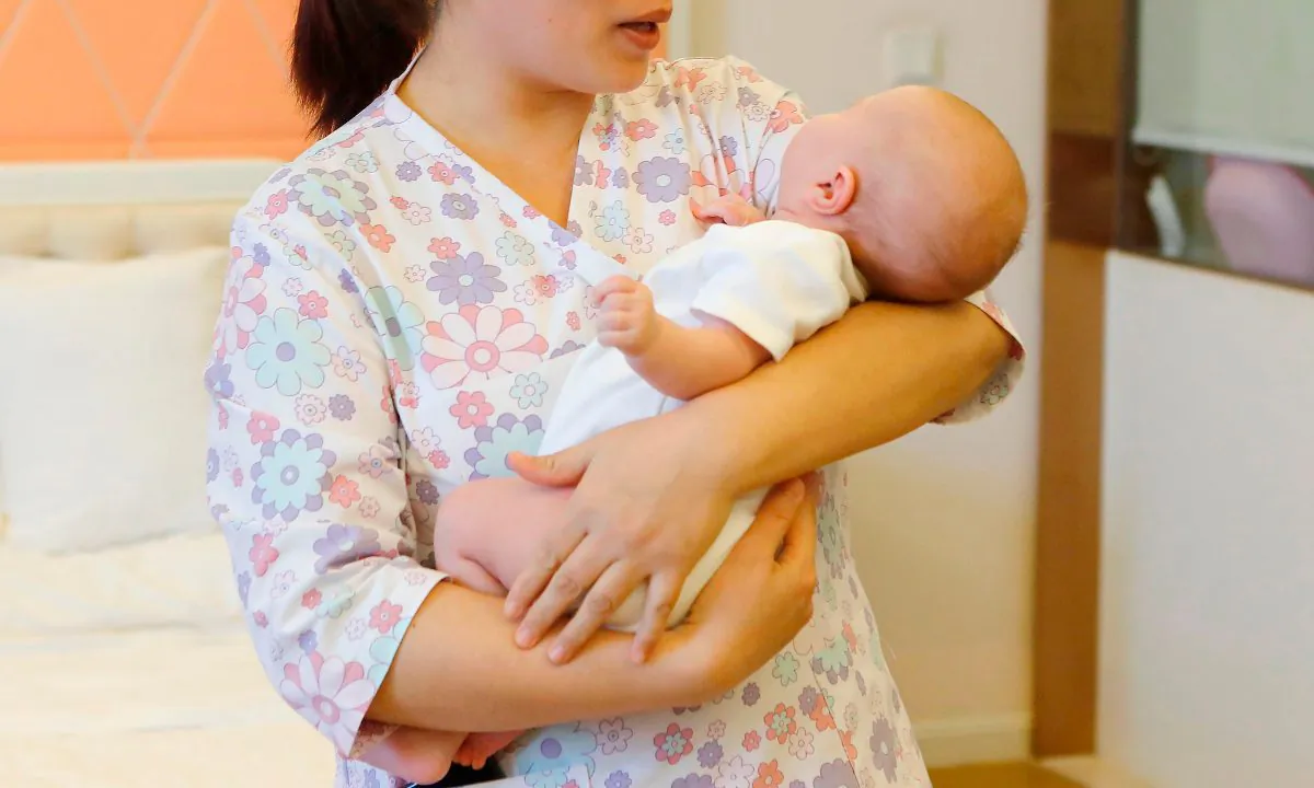 A woman holding a baby in a stock photo. (-/AFP/Getty Images)