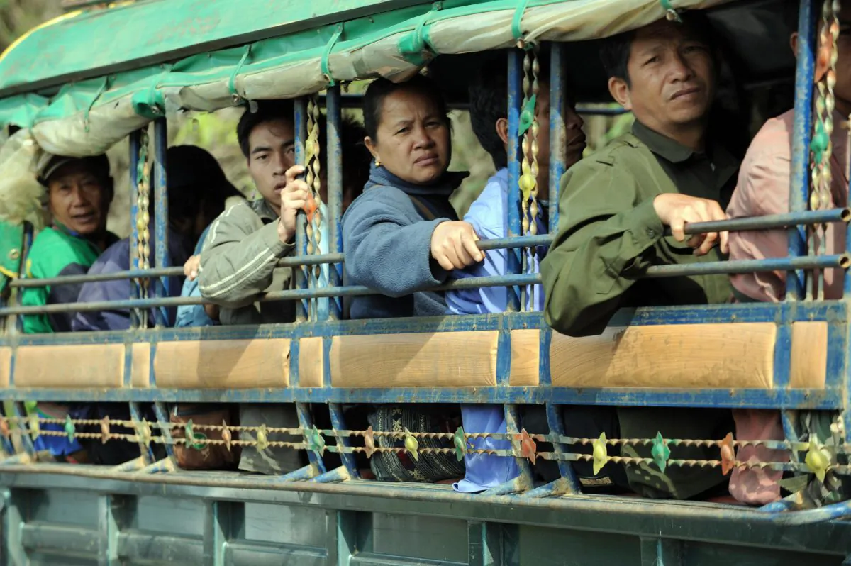 Passengers travel on a truck-turned-passenger bus on a road in Viengxay, in the northern Lao province of Houaphanh on April 4, 2008. (Hoang Dinh Nam/AFP/Getty Images)