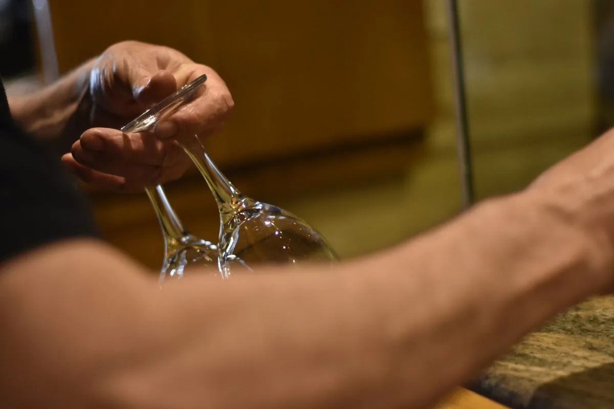 In this file image, a waiter carries a pair of wine glasses. (Pixabay)