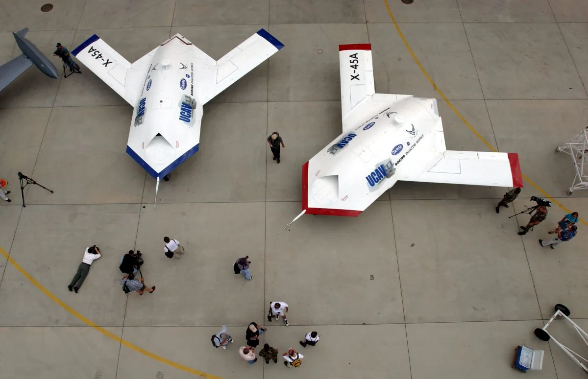 Two X-45A Unmanned Combat Air Vehicles (UCAV) are shown to members of the news media at Edwards Air Force Base, California, U.S. on July 11, 2002. The X-45A, developed by The Defense Advanced Research Projects Agency and the Boeing Company, is the first unmanned system designed from inception for combat missions. (David McNew/Getty Images)
