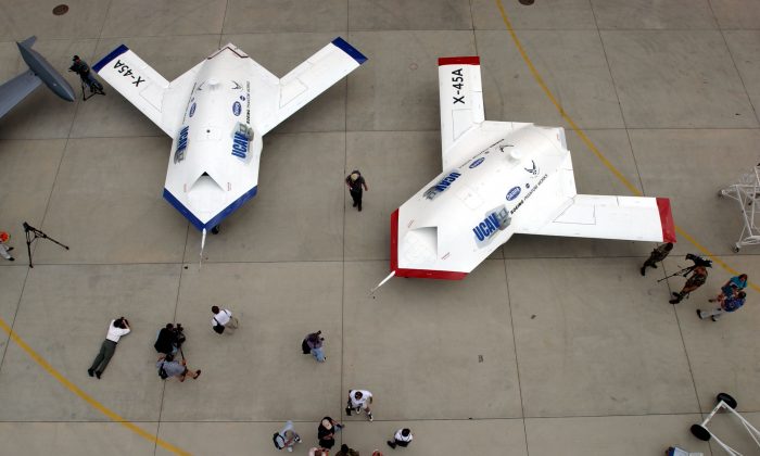 Two X-45A Unmanned Combat Air Vehicles (UCAV) are shown to members of the news media at Edwards Air Force Base, California, U.S. on July 11, 2002. The X-45A, developed by The Defense Advanced Research Projects Agency and the Boeing Company, is the first unmanned system designed from inception for combat missions. (David McNew/Getty Images)