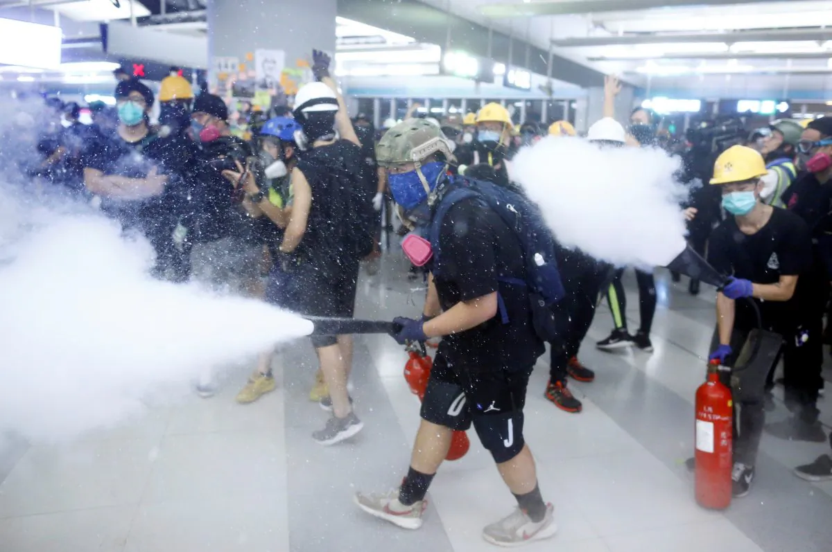 Protesters fire nitrogen extinguishers during a stand off at Yuen Long MTR station, the scene of an attack by suspected triad gang members Yuen Long, New Territories, Hong Kong, China on July 21, 2019. (Thomas Peter/Reuters)