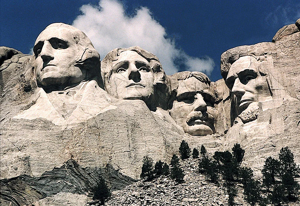 This June 1995 photo shows Mt. Rushmore, in Keystone, South Dakota. Sculptor Gutzon Borglum started work on Mt. Rushmore Aug. 10, 1927, and continued for 14 years, but only 6.5 years were actually spent sculpting due to harsh weather delays. The presidents were selected on the basis of what each symbolized. George Washington (L) represents the struggle for independence; Thomas Jefferson (2nd L), the idea of government by the people; Theodore Roosevelt (2nd R), for the 20th century role of the United States in world affairs; and Abraham Lincoln (R) for his ideas on equality and the permanent union of the states. (Karen Bleier/AFP/Getty Images)