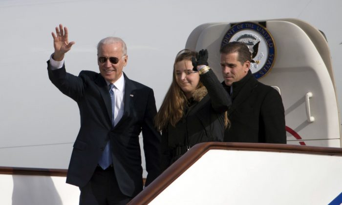 Then-Vice President Joe Biden waves as he walks out of Air Force Two with his granddaughter Finnegan Biden (C) and son Hunter Biden (R) at the airport in Beijing on Dec. 4, 2013. (Ng Han Guan-Pool/Getty Images)