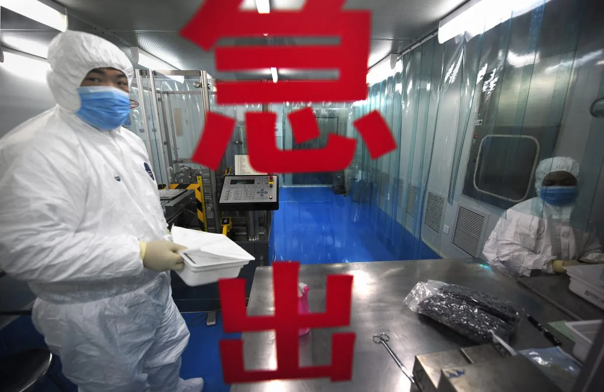 Lab technicians work at Chinese firm Sinovac Biotech in Beijing on Aug. 24, 2009. (Peter Parks/AFP/Getty Images)