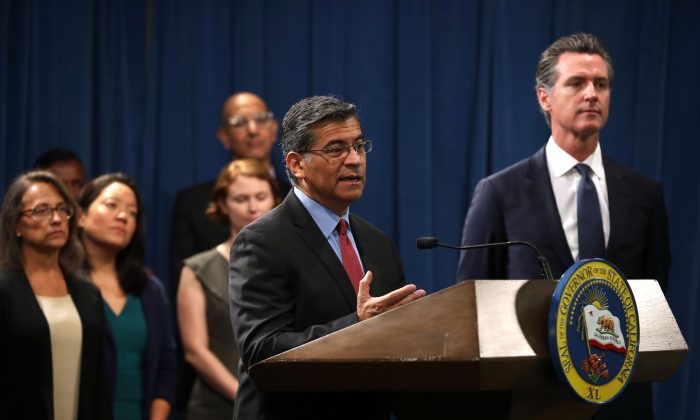 California attorney General Xavier Becerra (C) speaks during a news conference with California Gov. Gavin Newsom (R) at the California State Capitol in Sacramento, Calif., on Aug. 16, 2019. (Justin Sullivan/Getty Images)