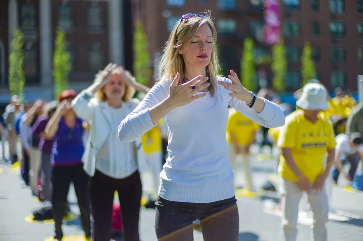 Falun Gong practitioners exercise at Union Square in New York as they celebrate World Falun Dafa Day on May 12, 2016. (The Epoch Times)
