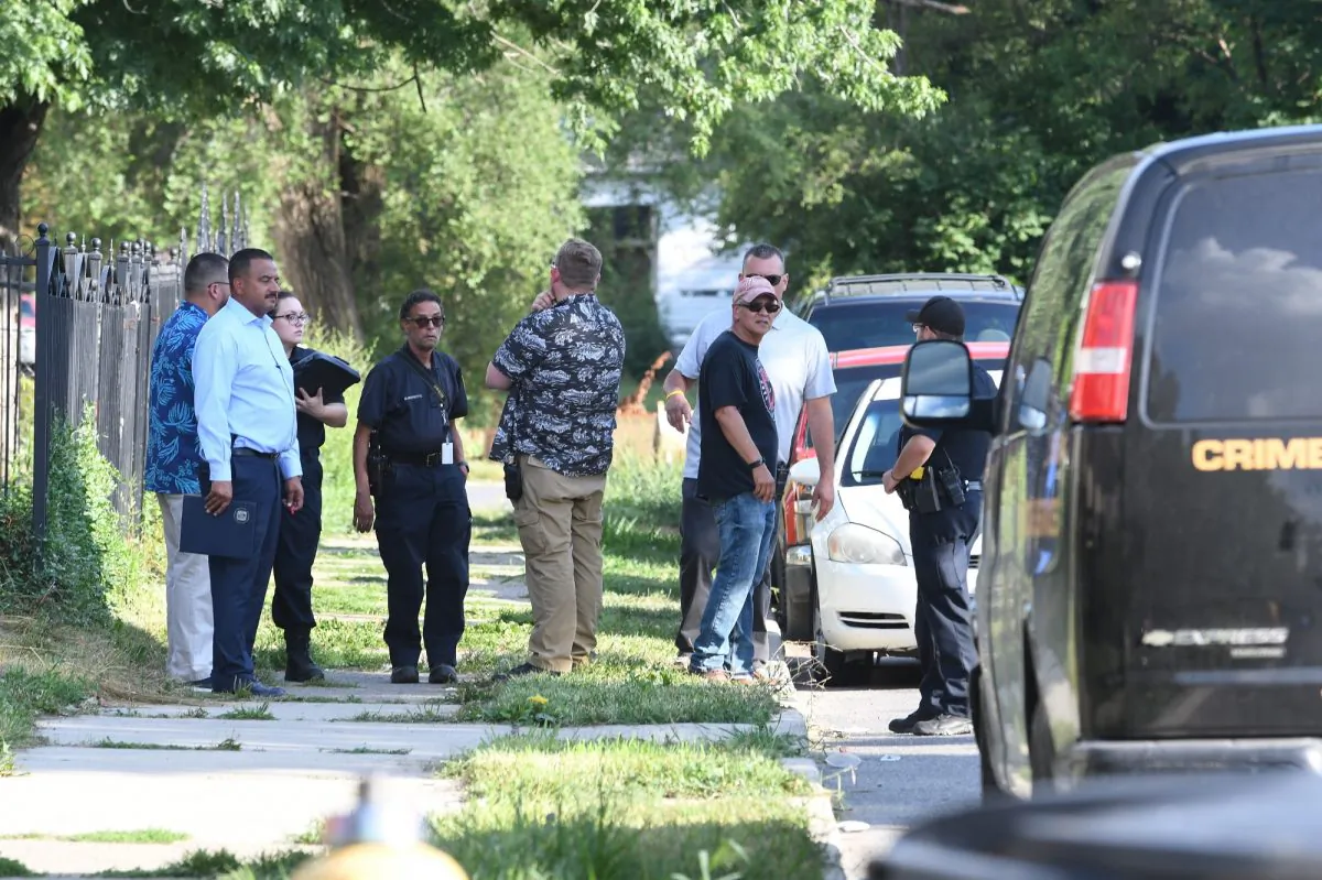Detroit police respond to the scene where three dogs attacked a young girl who later died of her injuries in Detroit on Aug. 19, 2019. (Max Ortiz/Detroit News via AP)