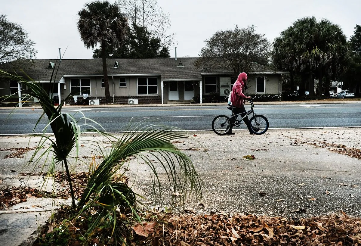 A man walks his bicycle in a struggling neighborhood in Pensacola, Fla., on Dec. 4, 2016. (Spencer Platt/Getty Images)