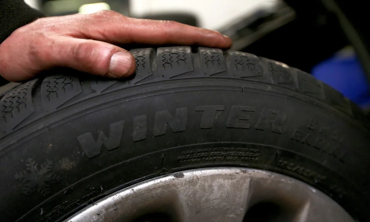 A man with his hand on a tire in this file photo. (Francois Nascimbeni/AFP/Getty Images)