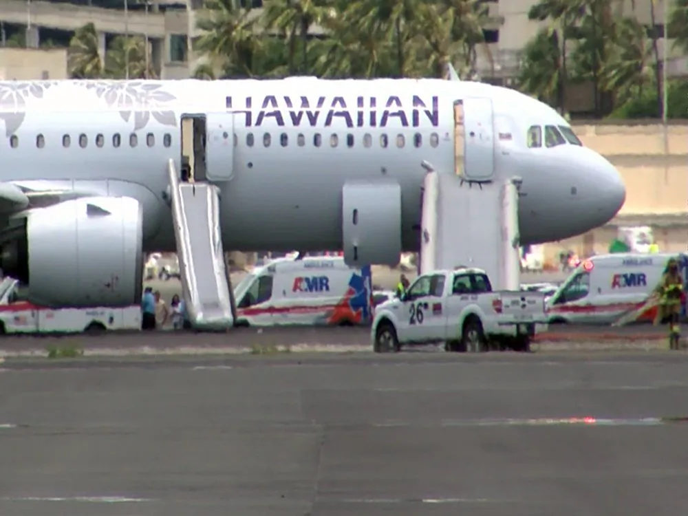This image taken from video provided by Hawaii News Now, shows Hawaiian Airlines Flight 47 on a runway after smoke filled the plane's cabin, forcing an emergency landing and evacuation on Aug. 22, 2019 in Honolulu. (Hawaii News Now via AP)